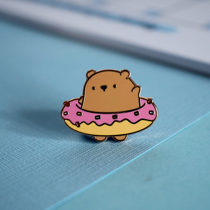Bear wearing a donut enamel pin 