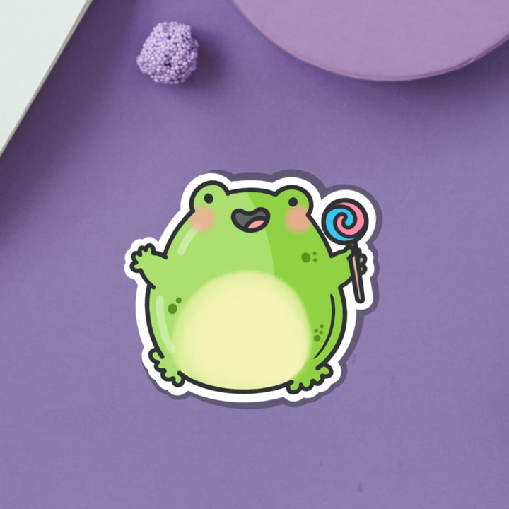 Jumping frog vinyl sticker on purple table