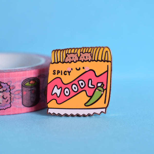 Noodles enamel pin with washi tape on blue background