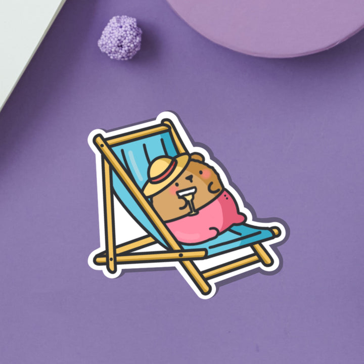 Bear Sunbathing vinyl sticker on purple table