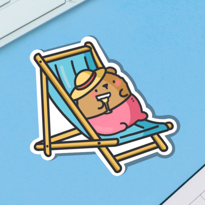 Bear Sunbathing vinyl sticker on blue table