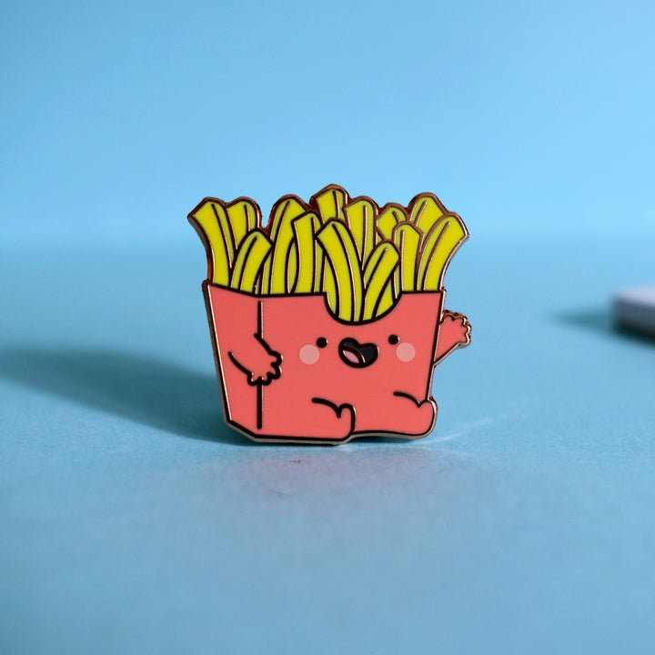 French fries enamel pin on blue background