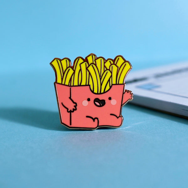 French fries enamel pin on blue table