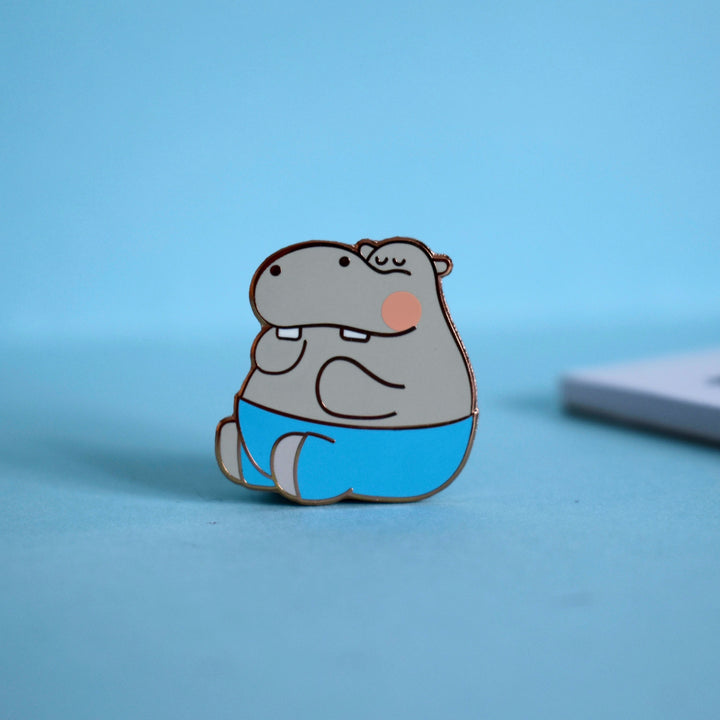 Hippo enamel pin on blue background
