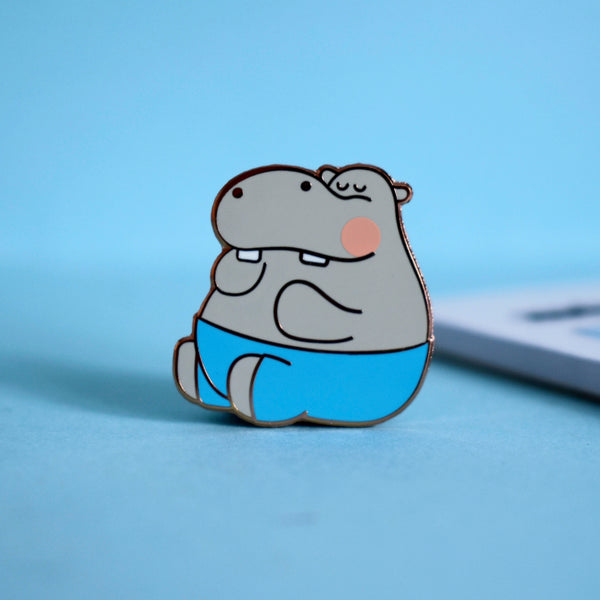 Hippo enamel pin on blue background