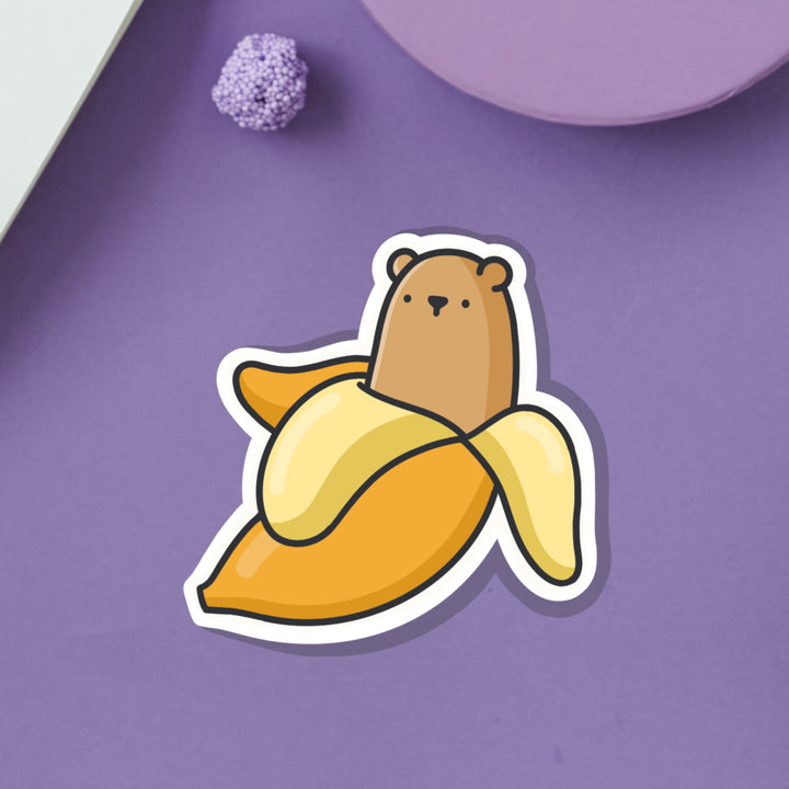 Bear in a banana vinyl sticker on purple background