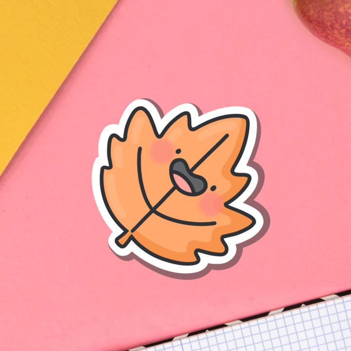 Leaf Vinyl Sticker on pink table and notebook