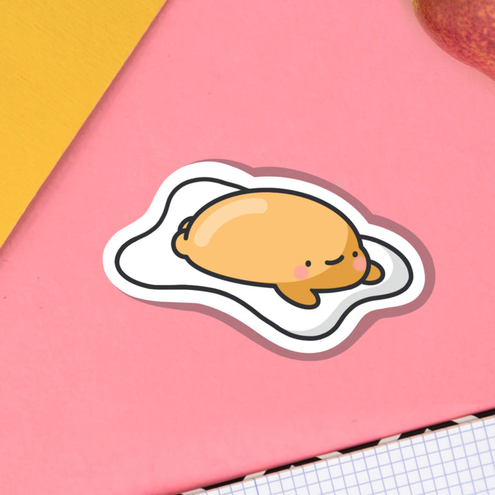 Fried egg vinyl sticker on pink desk 