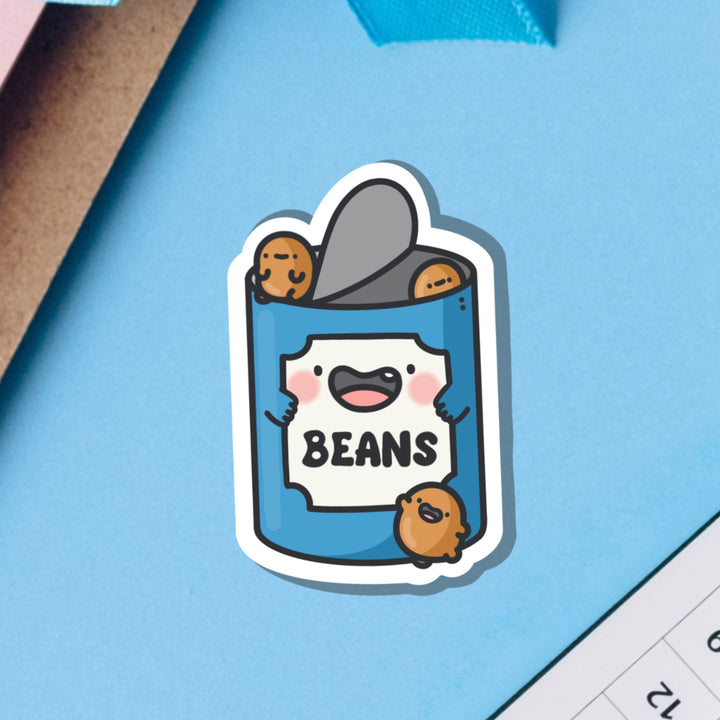 Baked Beans Vinyl Sticker on blue table