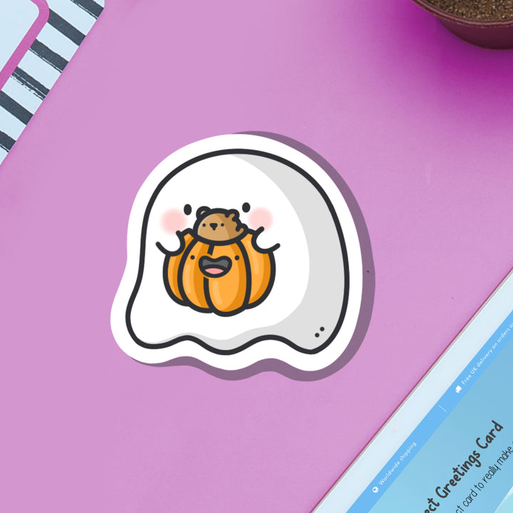 Ghost with pumpkin vinyl sticker on purple table with ipad