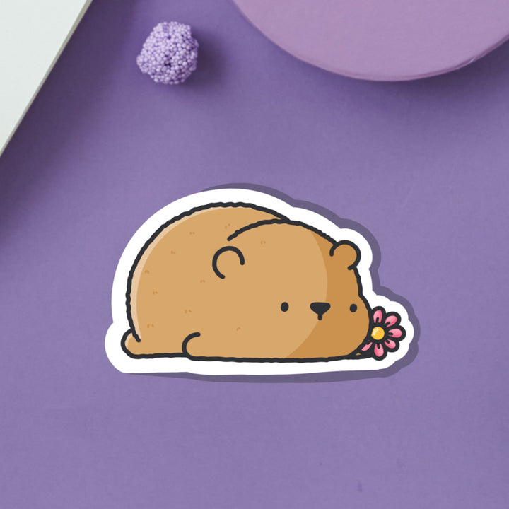 Bear lying down vinyl sticker on purple background