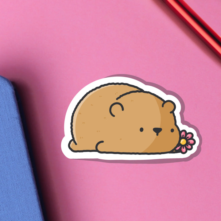 Bear lying down vinyl sticker on pink table