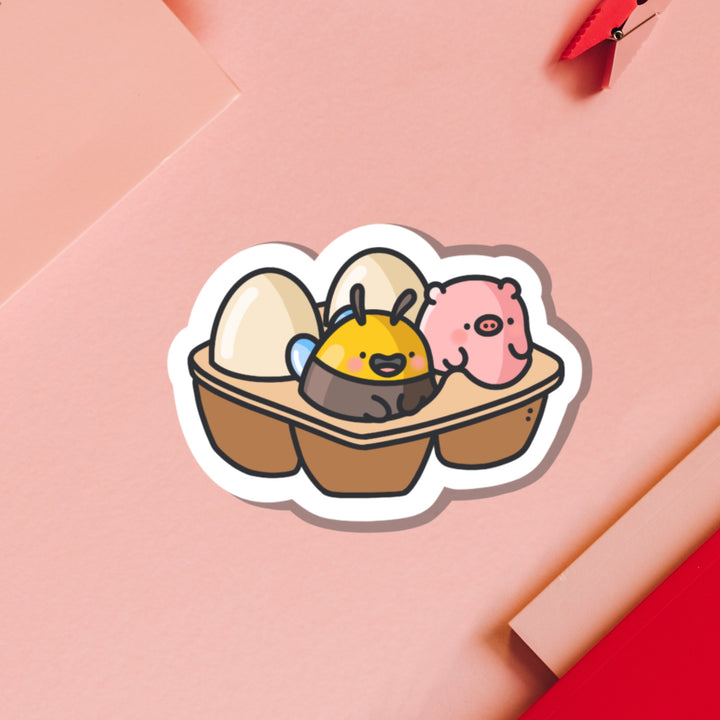 Egg carton with pig and bee vinyl sticker on pink background