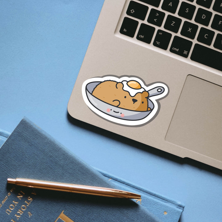 Bear in a frying pan vinyl sticker on laptop