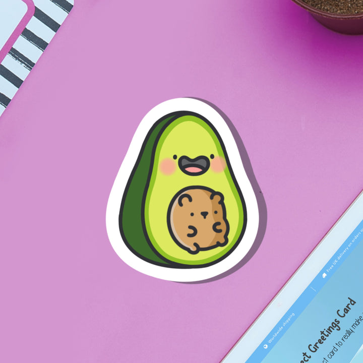 Avocado with bear vinyl sticker on purple table with ipad