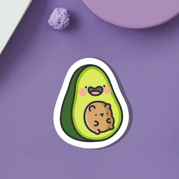 Avocado with bear vinyl sticker on purple table