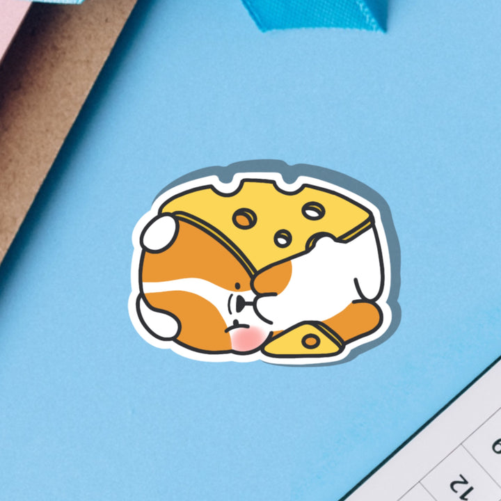 Dog wrapped in cheese vinyl sticker on blue table