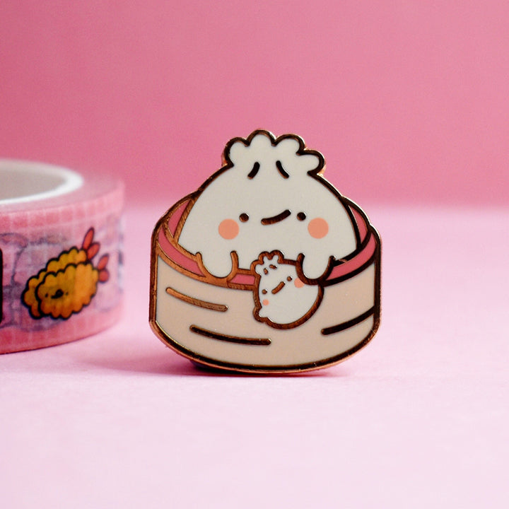 Cute Dumpling Enamel Pin on pink table