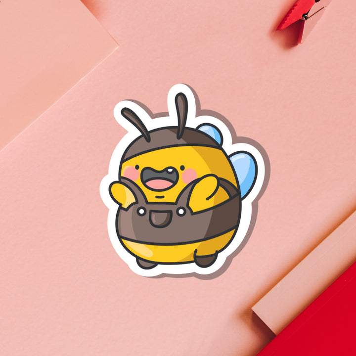 Bumblebee wearing dungarees vinyl sticker on pink table