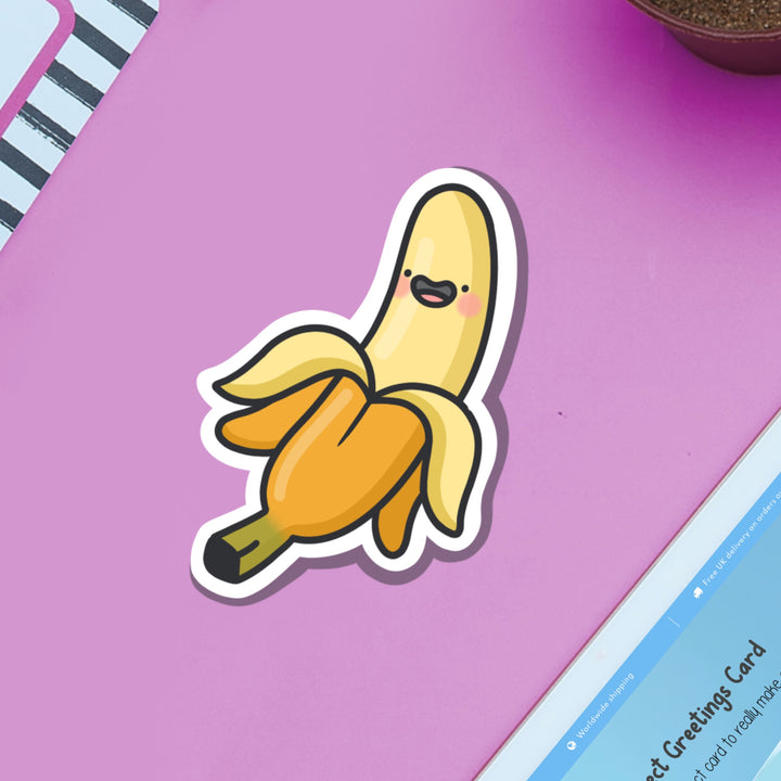 Happy banana vinyl sticker on purple table