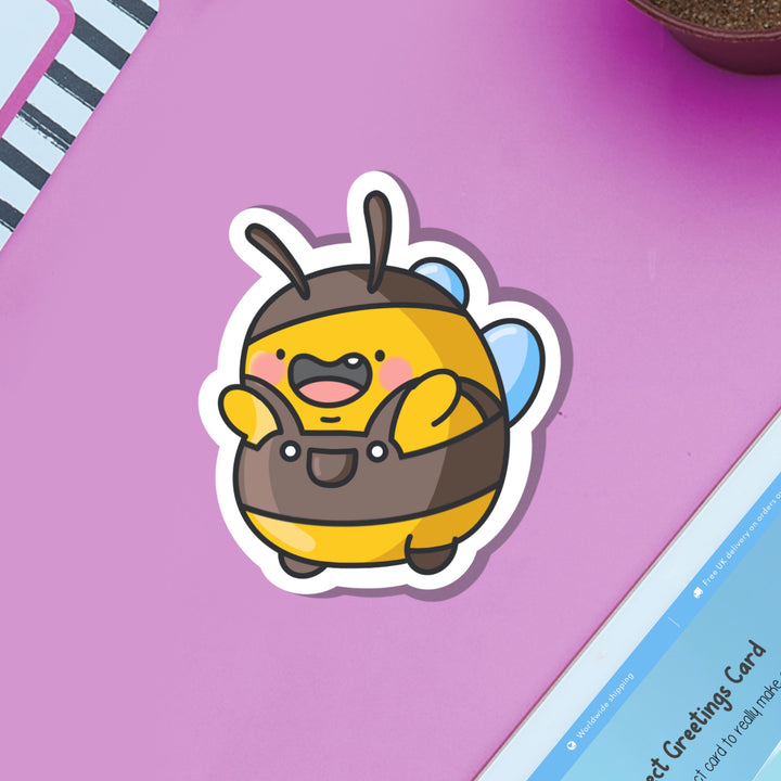 Bumblebee wearing dungarees vinyl sticker on purple table and ipad
