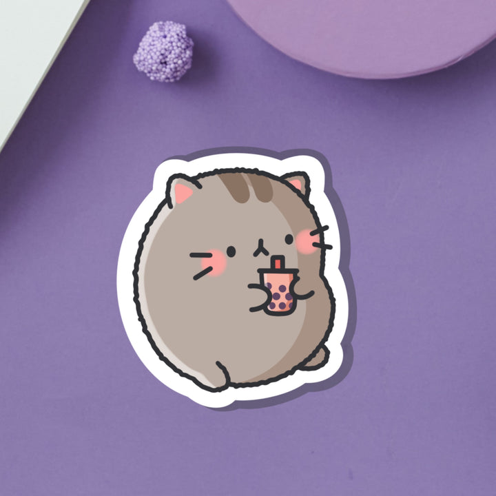 Cat drinking bubble tea vinyl sticker on purple table