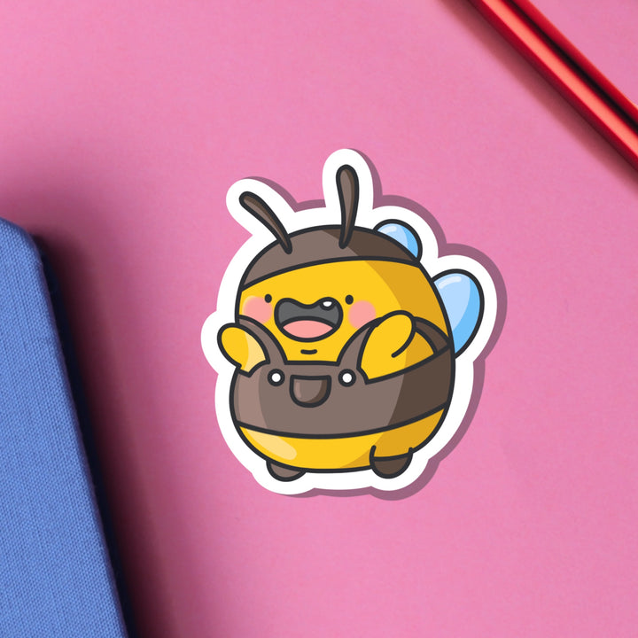 Bumblebee wearing dungarees vinyl sticker on pink background