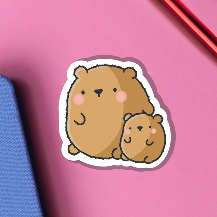 Big bear and baby bear vinyl sticker on pink table and notebook
