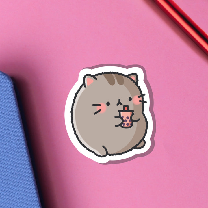 Cat drinking bubble tea vinyl sticker on pink table