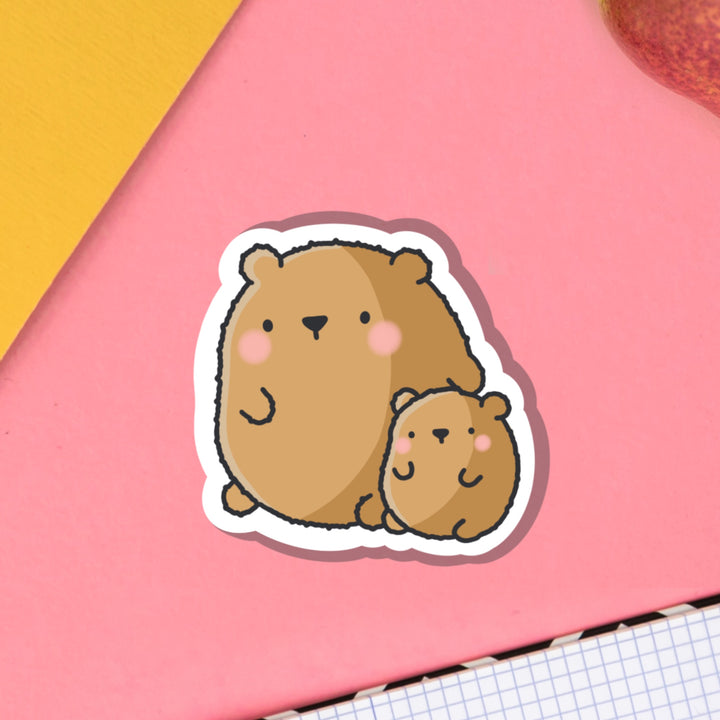 Big bear and baby bear vinyl sticker on pink table with notebook