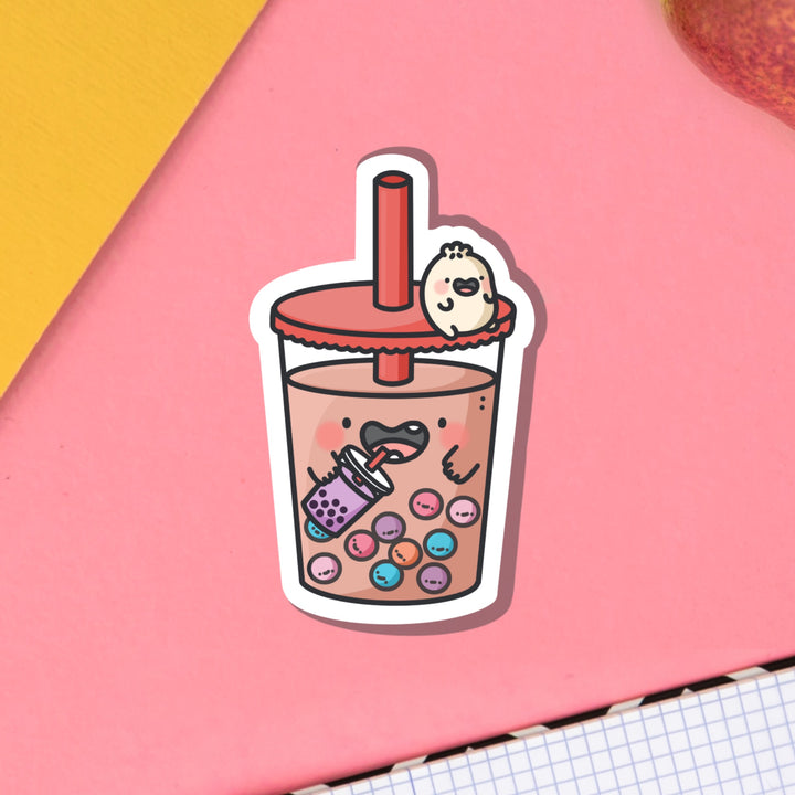 Dumpling on bubble tea vinyl sticker on pink table and notebook