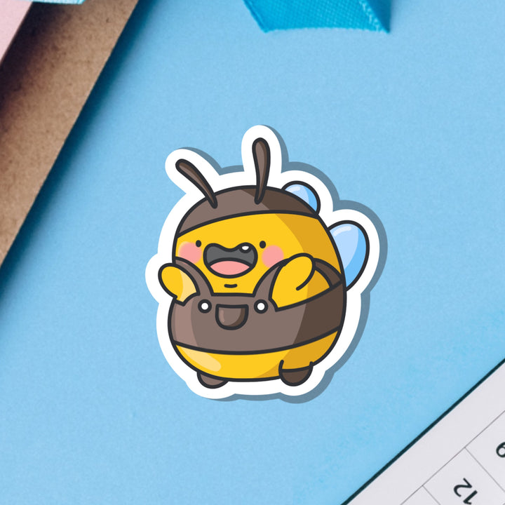 Bumblebee wearing dungarees vinyl sticker on blue background