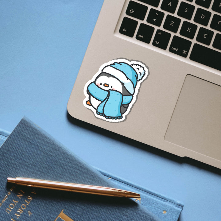 Penguin in scarf and wooly hat vinyl sticker on laptop