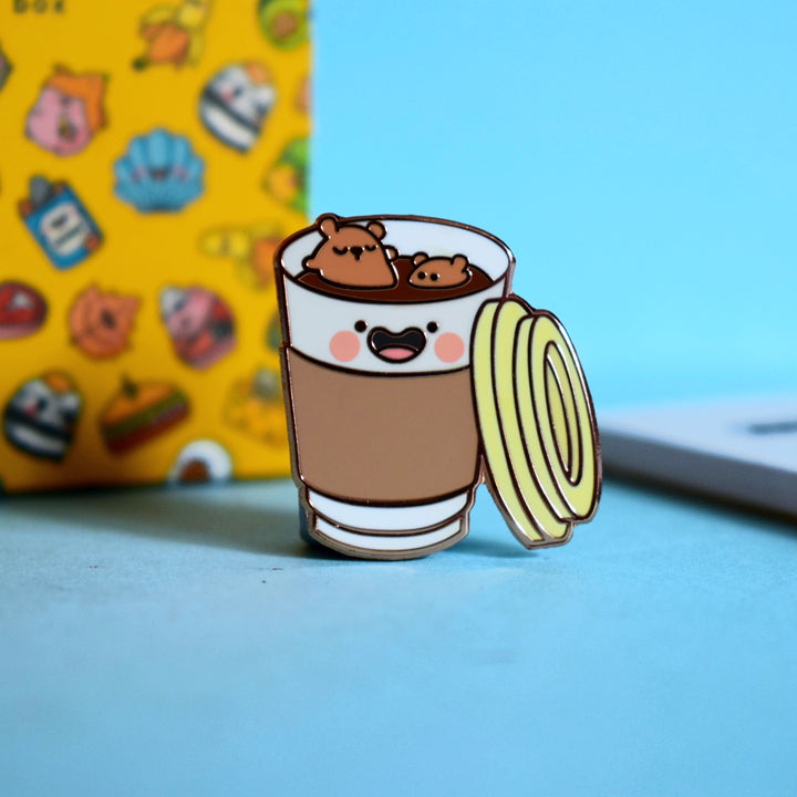 Coffee Cup Enamel pin on blue table
