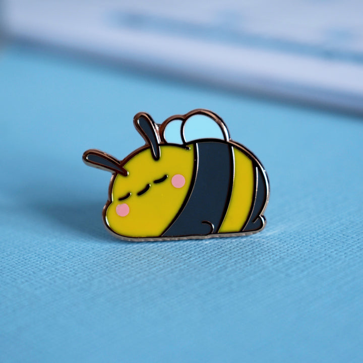 Bee pin on blue table