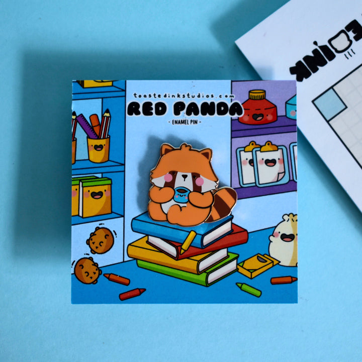 Red Panda enamel pin on bookshop backing card