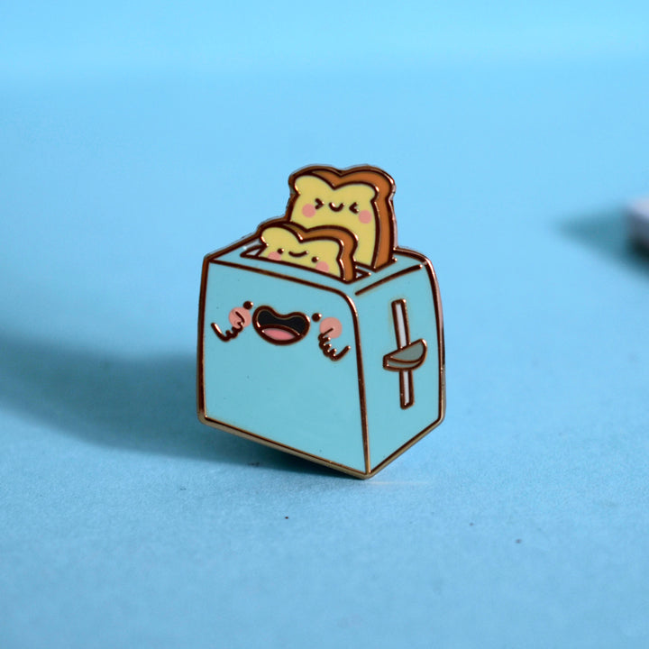 Toaster enamel pin on blue background