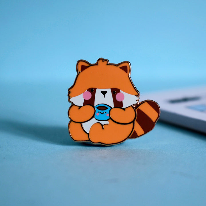 Red Panda enamel pin on blue background