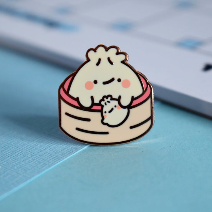 Dumpling holding baby dumpling pin with notepad